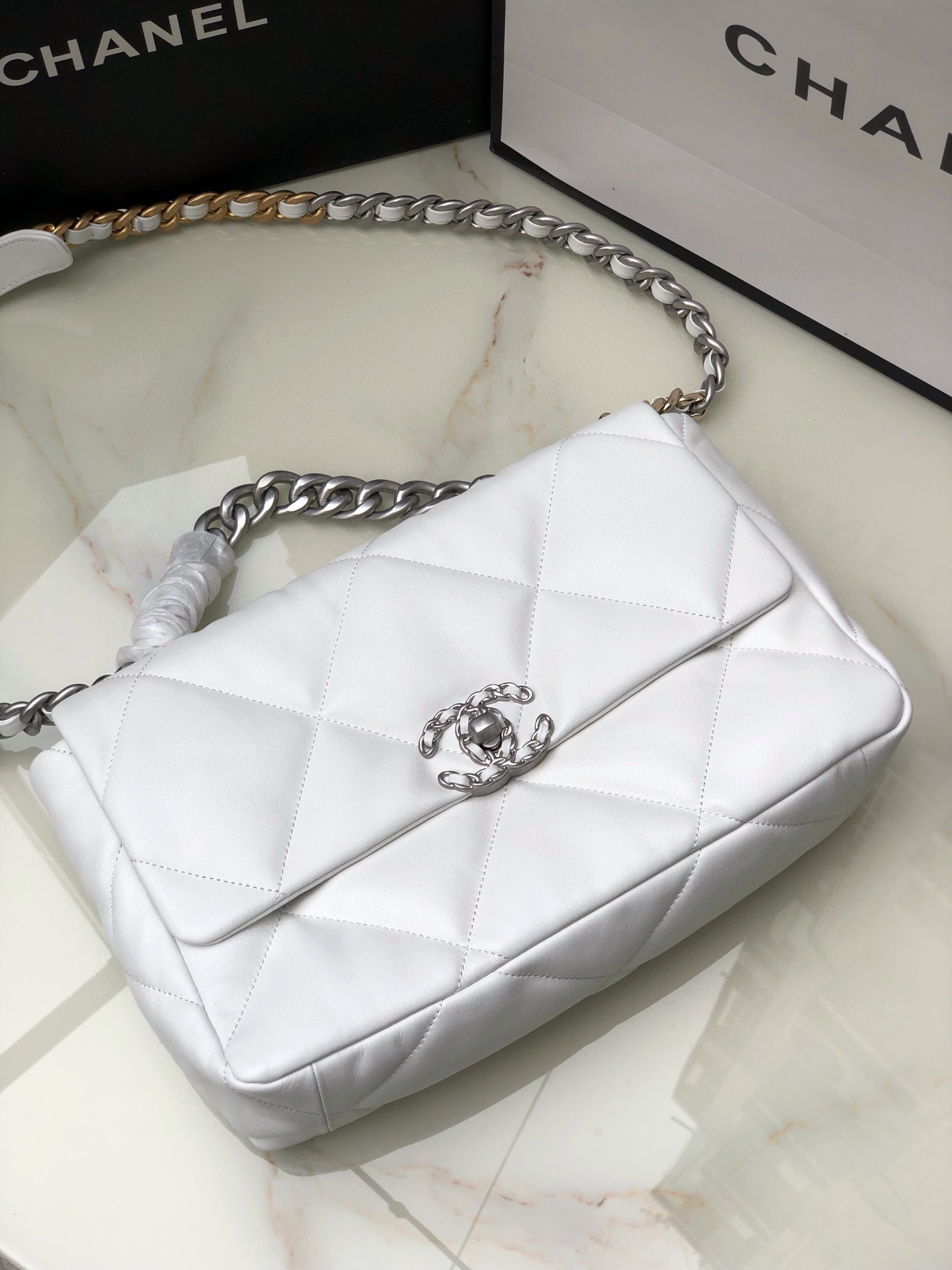 Ch*el 19 large handbag shiny leather, gold-tone, silver-tone & ruthenium-finish metal white 7.8 × 11.7 × 3.9 in