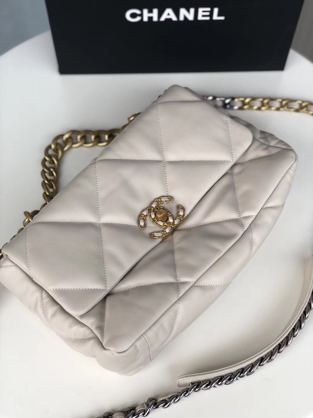 Ch*el 19 large handbag shiny leather, gold-tone, silver-tone & ruthenium-finish metal beige 7.8 × 11.7 × 3.9 in