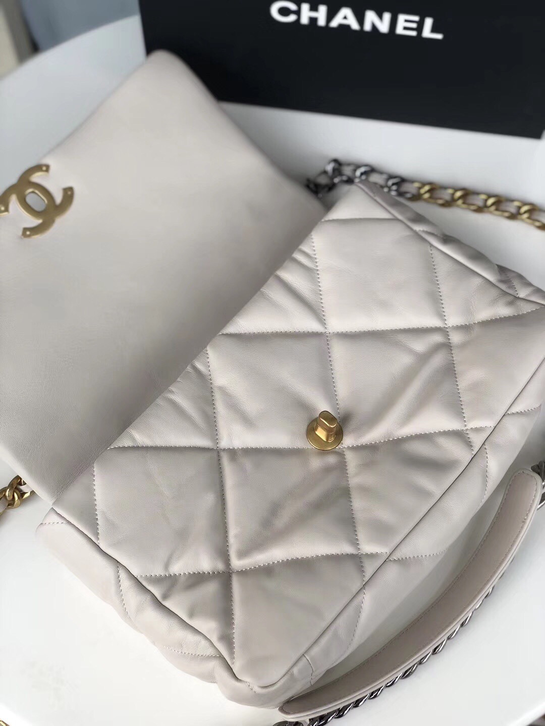 Ch*el 19 large handbag shiny leather, gold-tone, silver-tone & ruthenium-finish metal beige 7.8 × 11.7 × 3.9 in