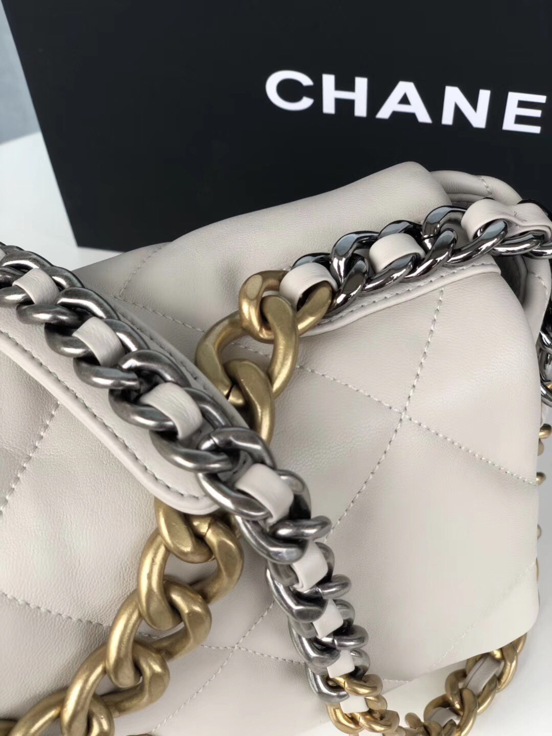 Ch*el 19 large handbag shiny leather, gold-tone, silver-tone & ruthenium-finish metal beige 7.8 × 11.7 × 3.9 in